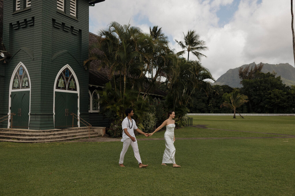 bride and groom walking and holding hands in maui