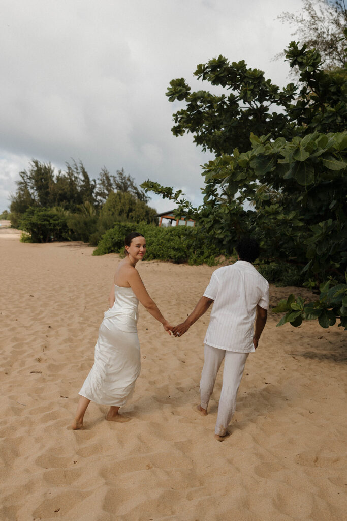 playful bride and groom photos on the beach