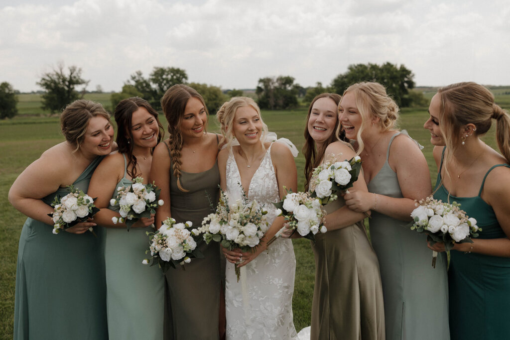 bride smiling and laughing with her bridesmaids