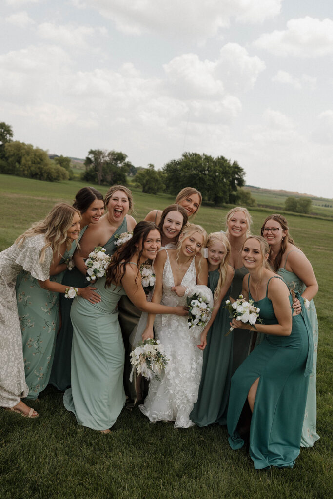 bride smiling and laughing with her bridesmaids