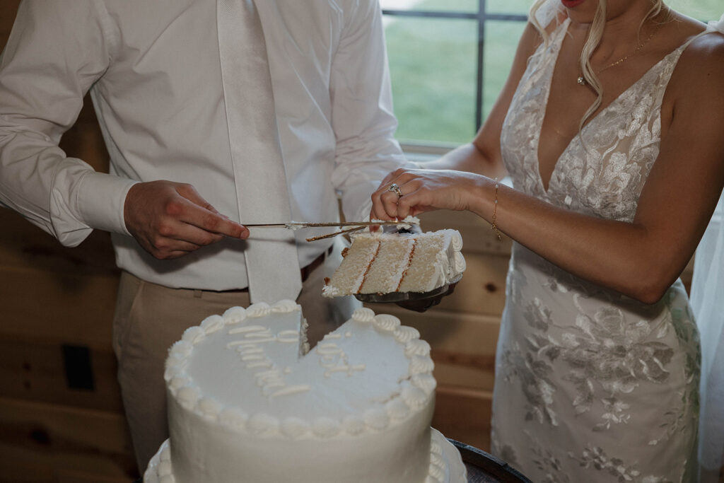 bride and groom cutting the wedding cake