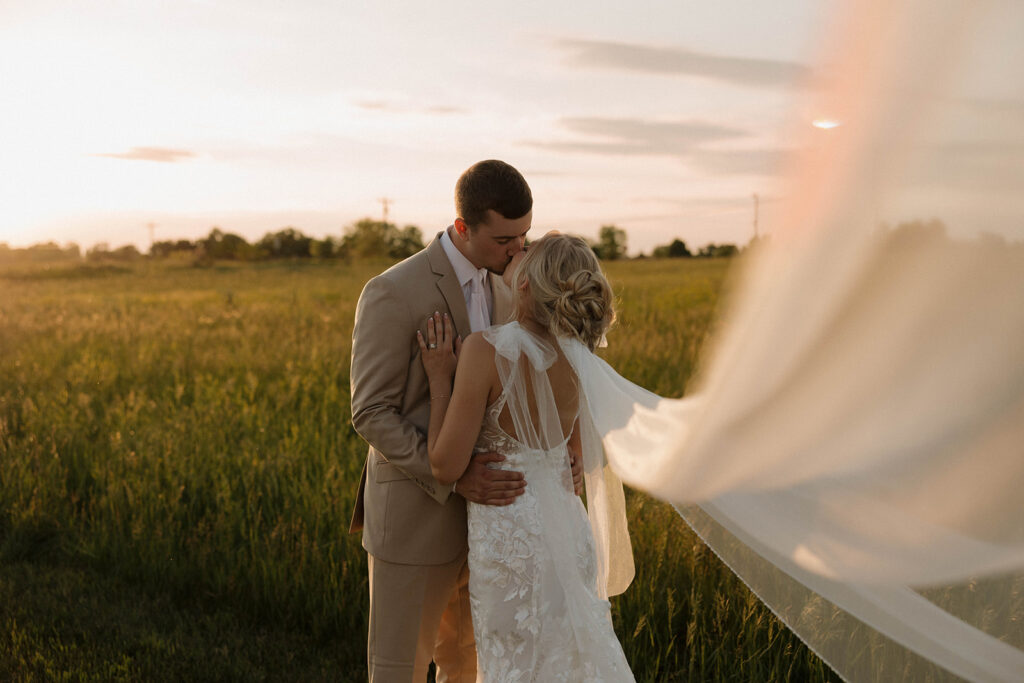 sunset wedding pictures with the bride and groom at riverview barn