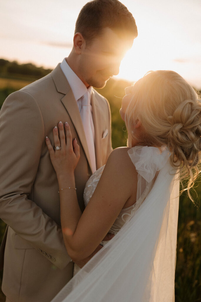 sunset wedding pictures with the bride and groom at riverview barn