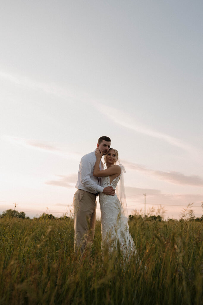 sunset wedding pictures with the bride and groom at riverview barn