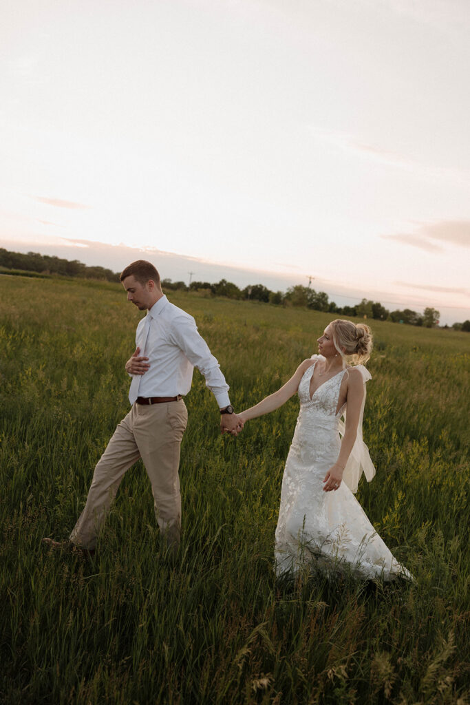 sunset wedding pictures with the bride and groom at riverview barn