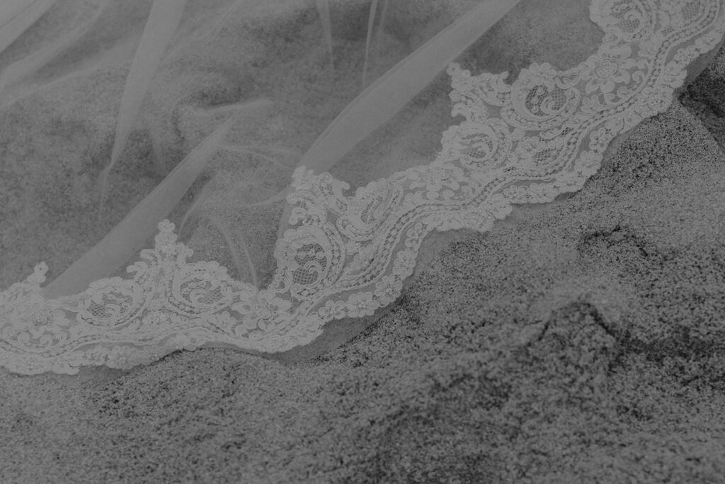 wedding veil in the sand detail shot