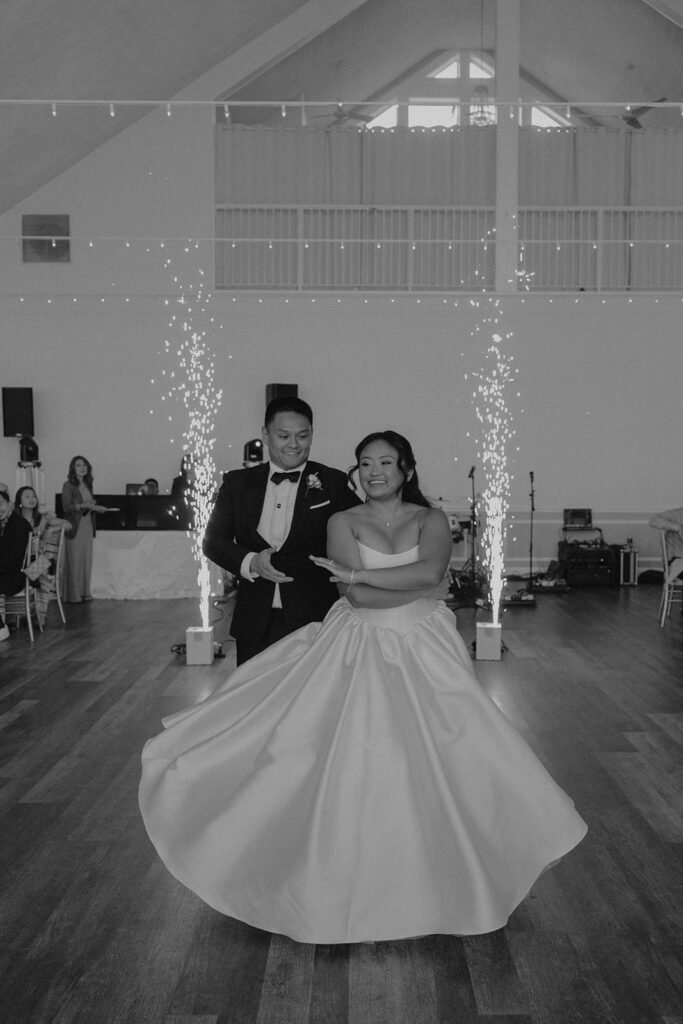 bride and groom first dance with sparklers in the background