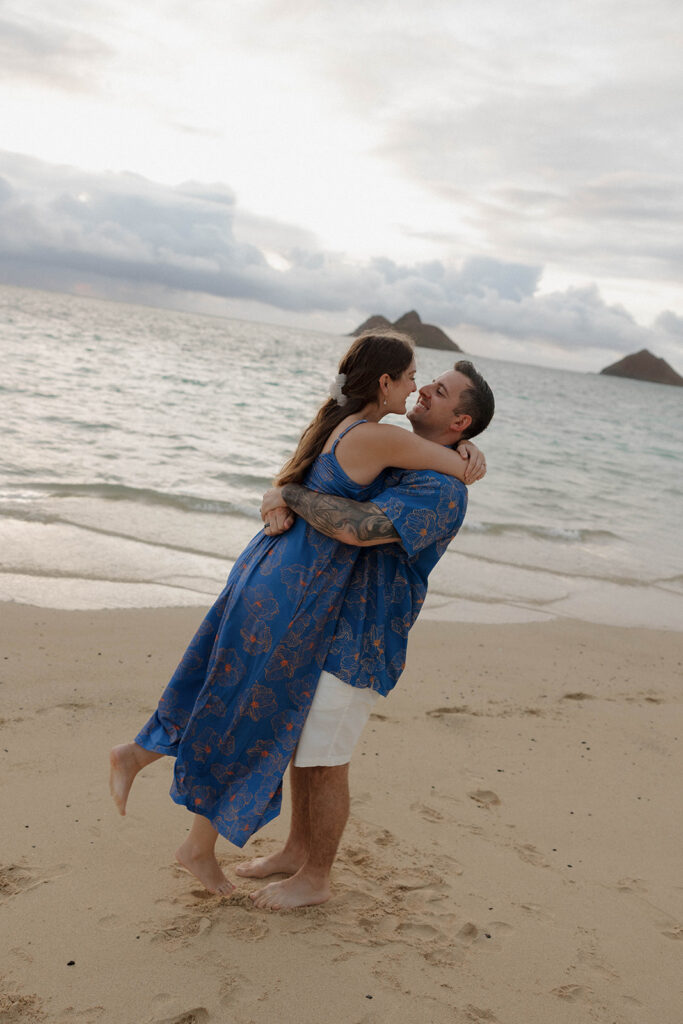 couple spinning on the shore and smiling