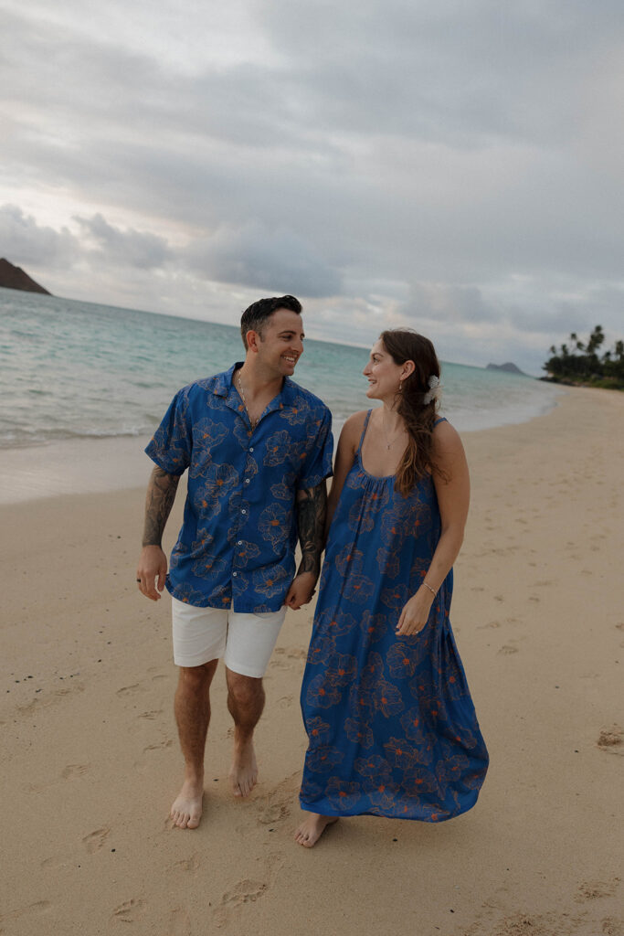 couple walking and holding hands on the beach
