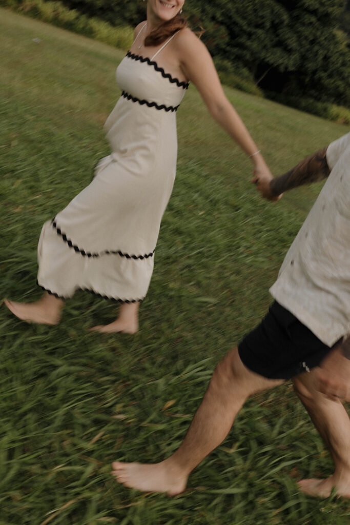 couple holding hands and running in hawaii