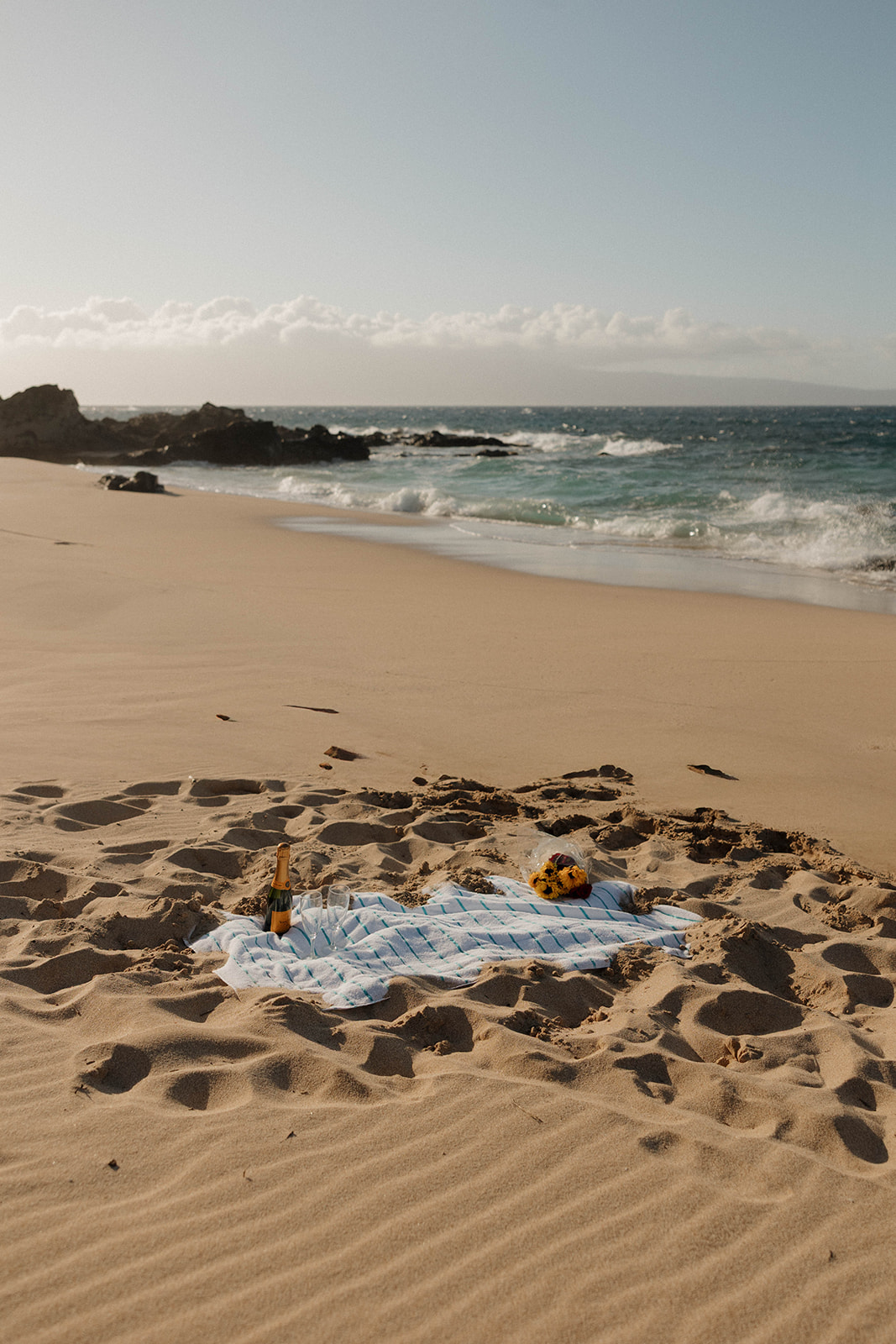 the beach picnic set up for a proposal, captured by a Maui proposal photographer