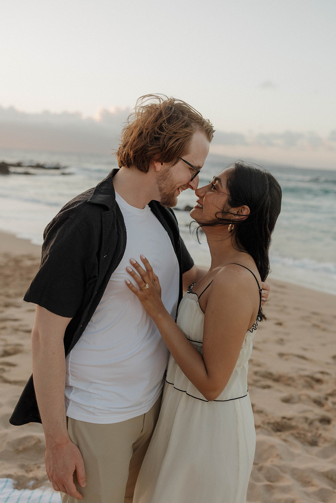 a couple hugging each other after just getting engaged