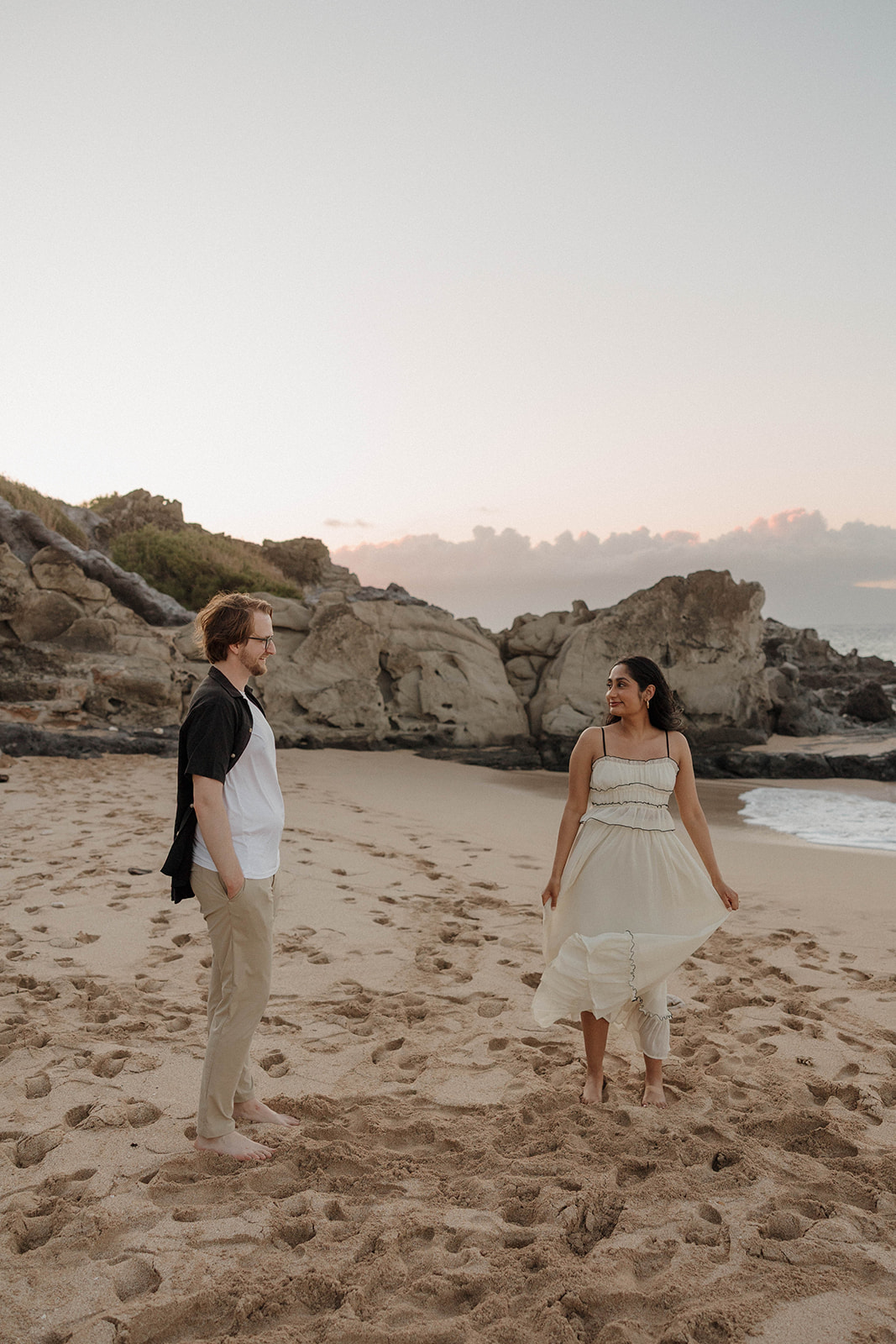 a couple having fun on the beach after their Maui proposal 