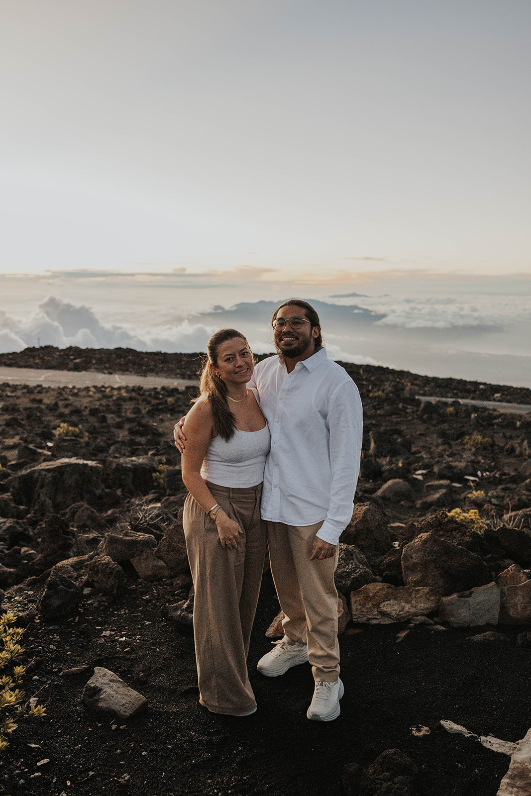 a couple smiling for a portrait after getting engaged at one of Maui's best engagement photo locations
