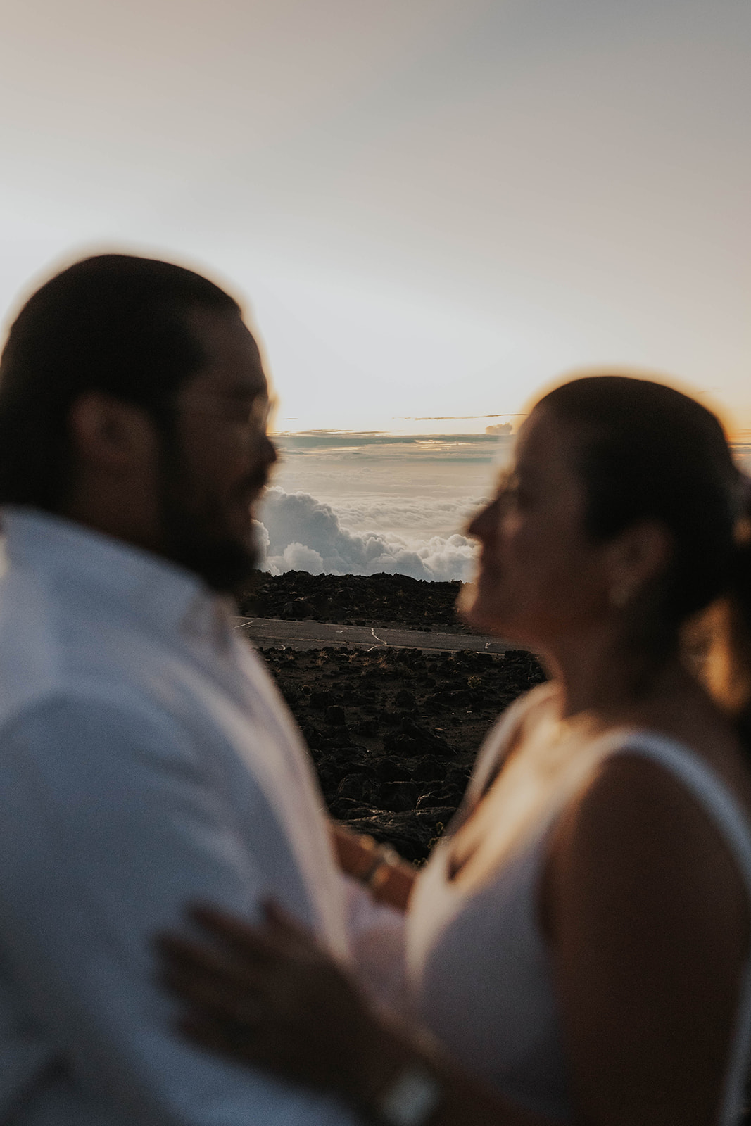 a couple blurred out and the clouds behind them in focus, captured by a Maui proposal photographer