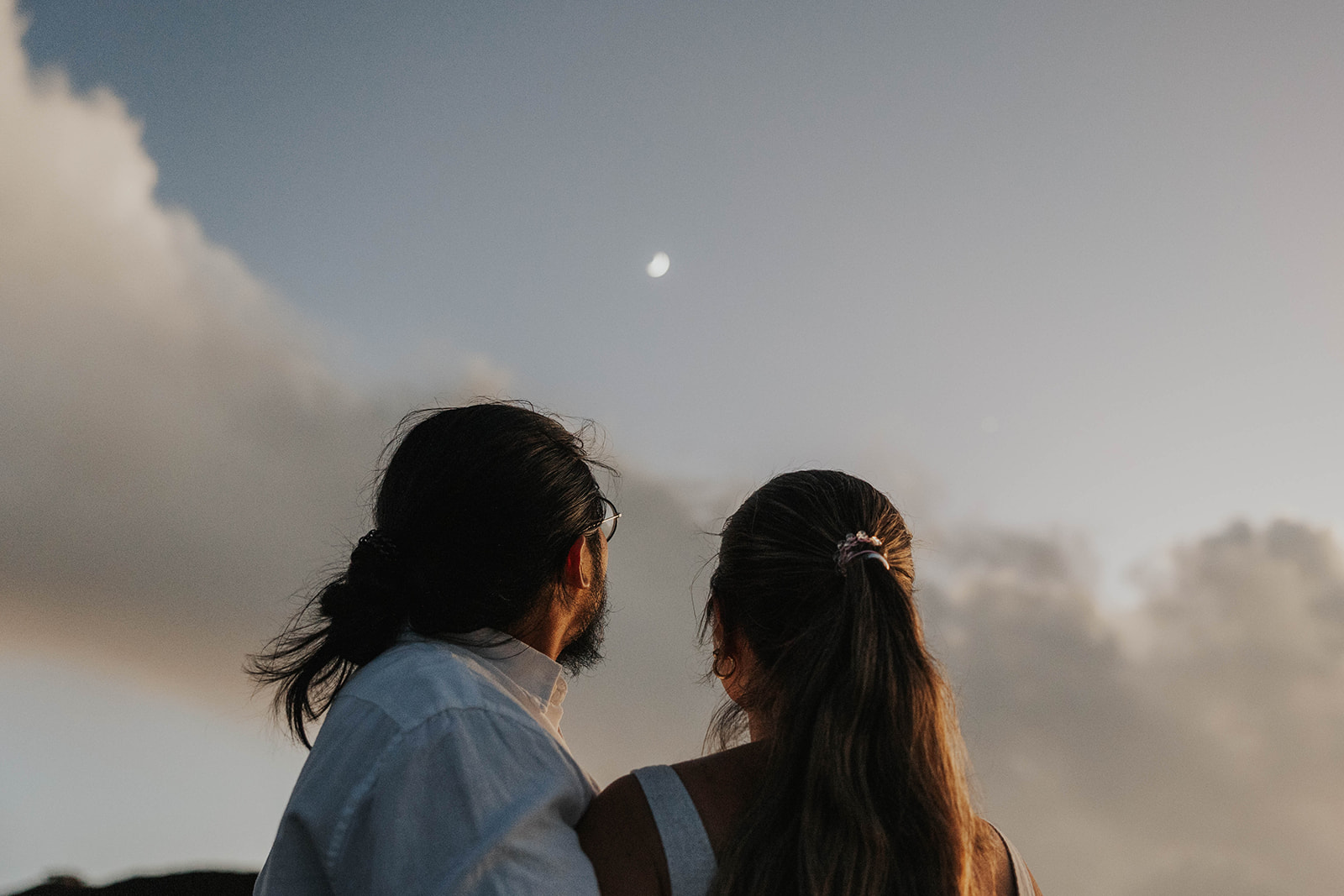 a couple looking up to the moon together during their Maui proposal photos