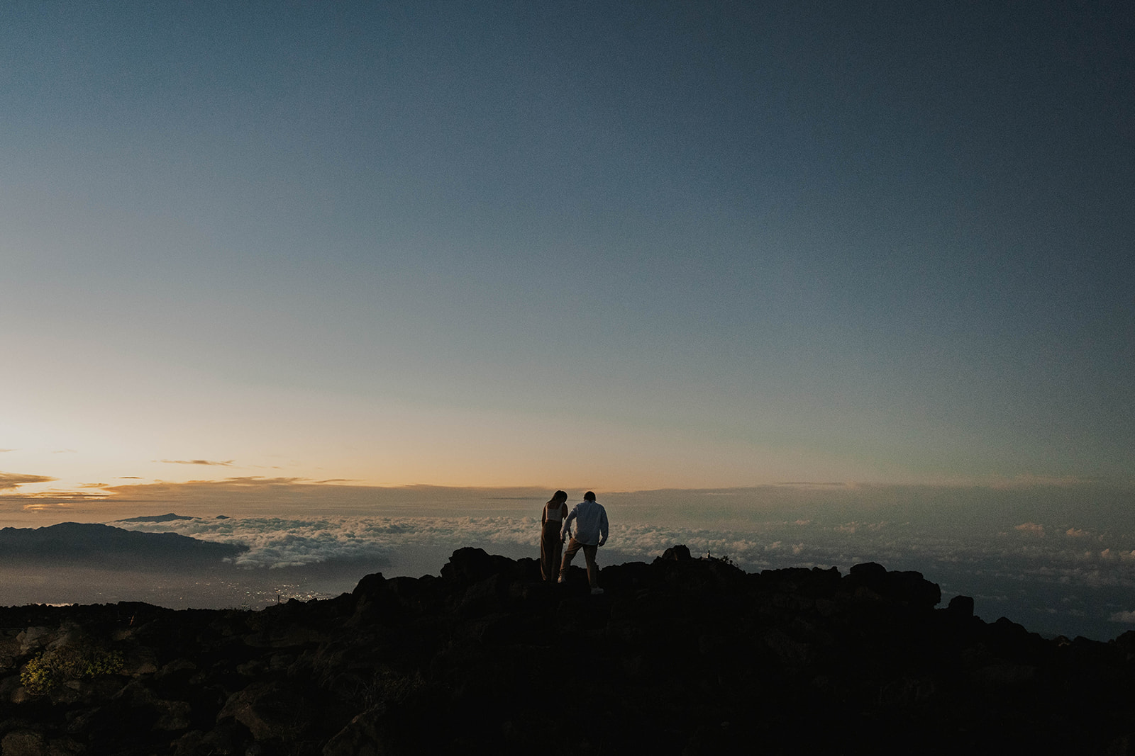 a couple on a mountain above the clouds during a Maui proposal photoshoot