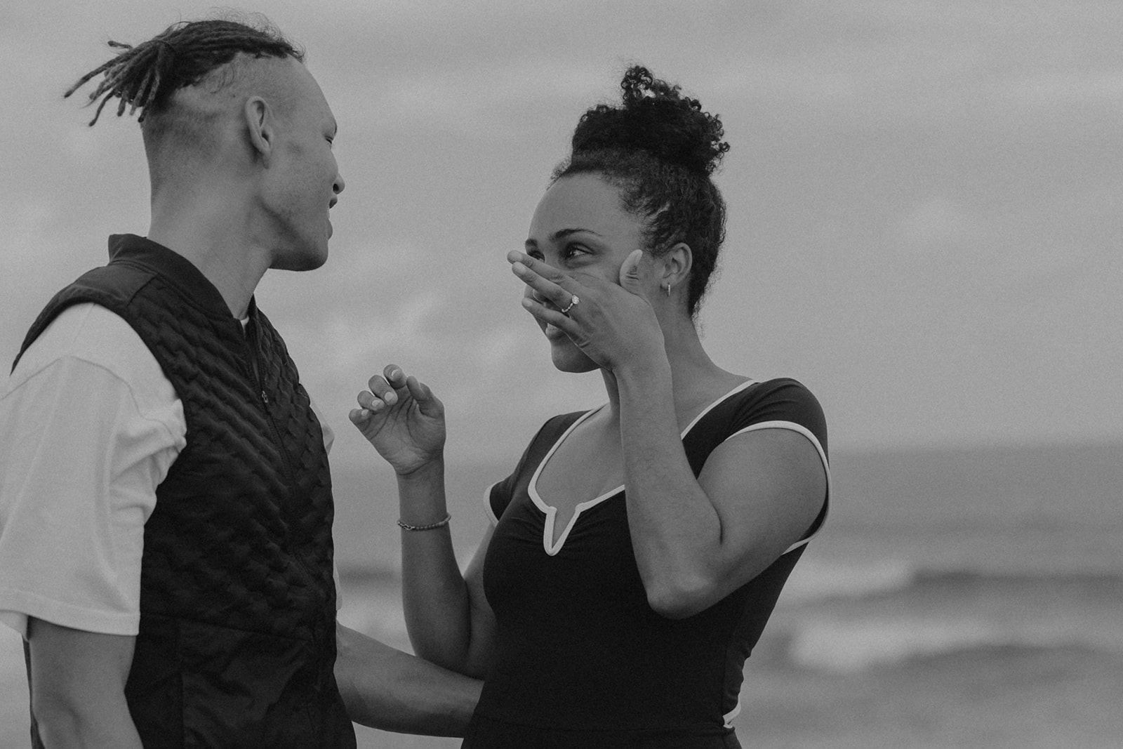a woman wiping her tears after she just got engaged 