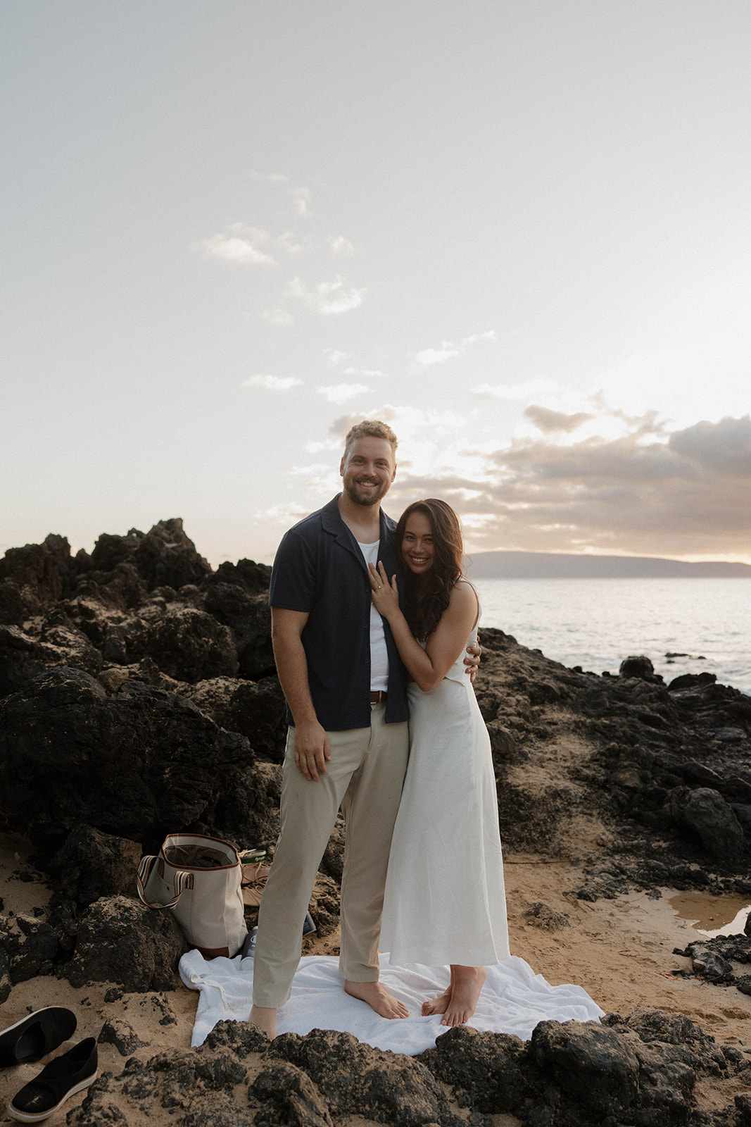 the happy newly engaged couple smiling for a portrait at one of Maui's best engagement photo locations