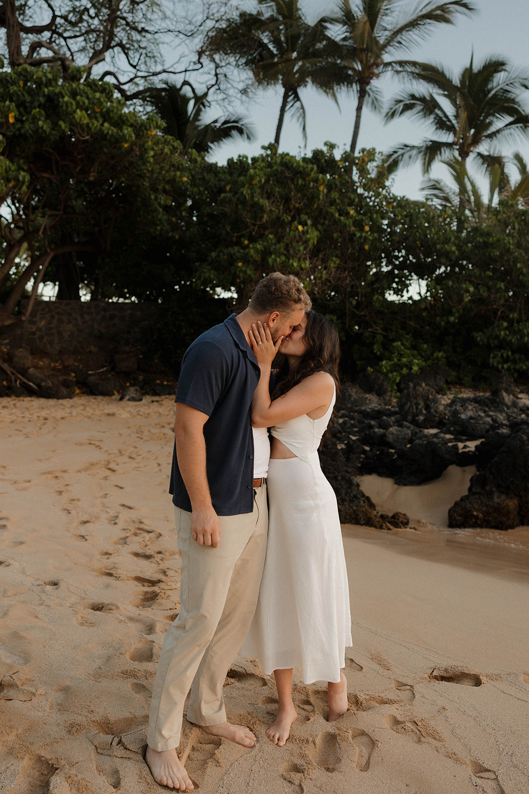 a couple kissing on the beach at one of Maui's best engagement photo locations
