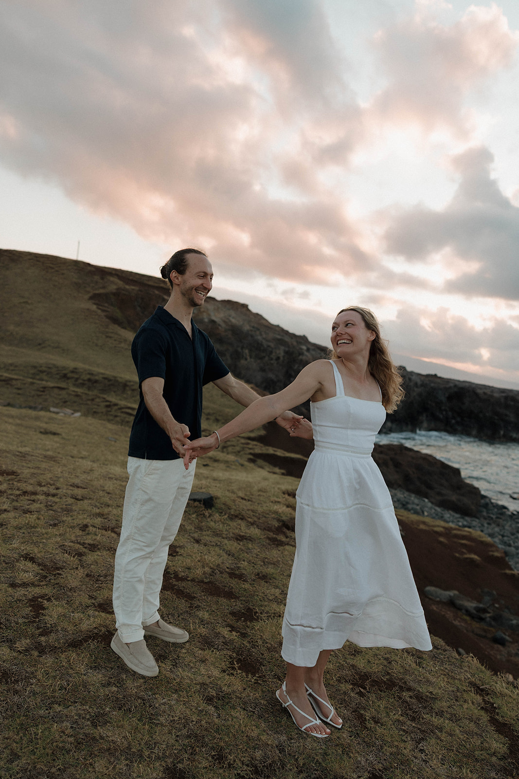 a couple dancing and laughing during their Maui engagement photos 