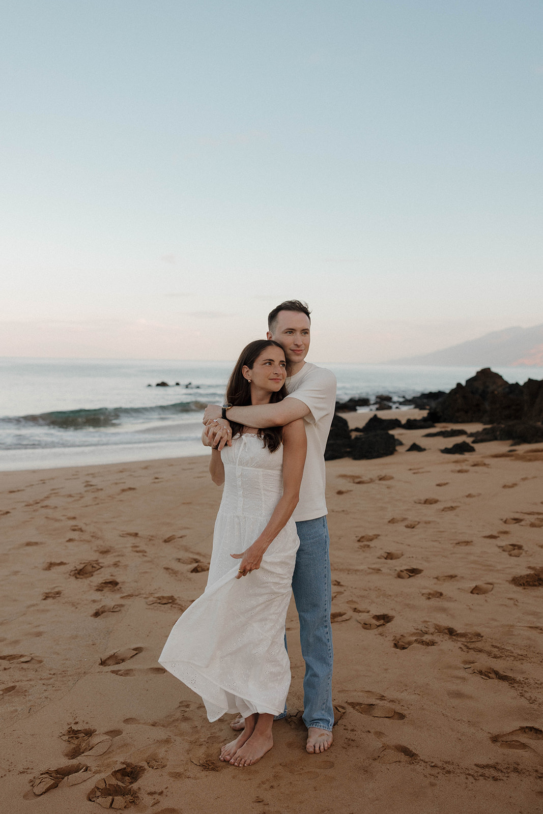 a couple standing together on the beach for their Hawaii engagement photos