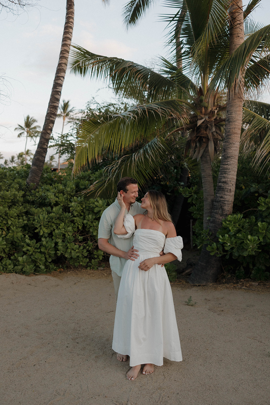 a couple cuddling into each other as they enjoy their engagement photo session