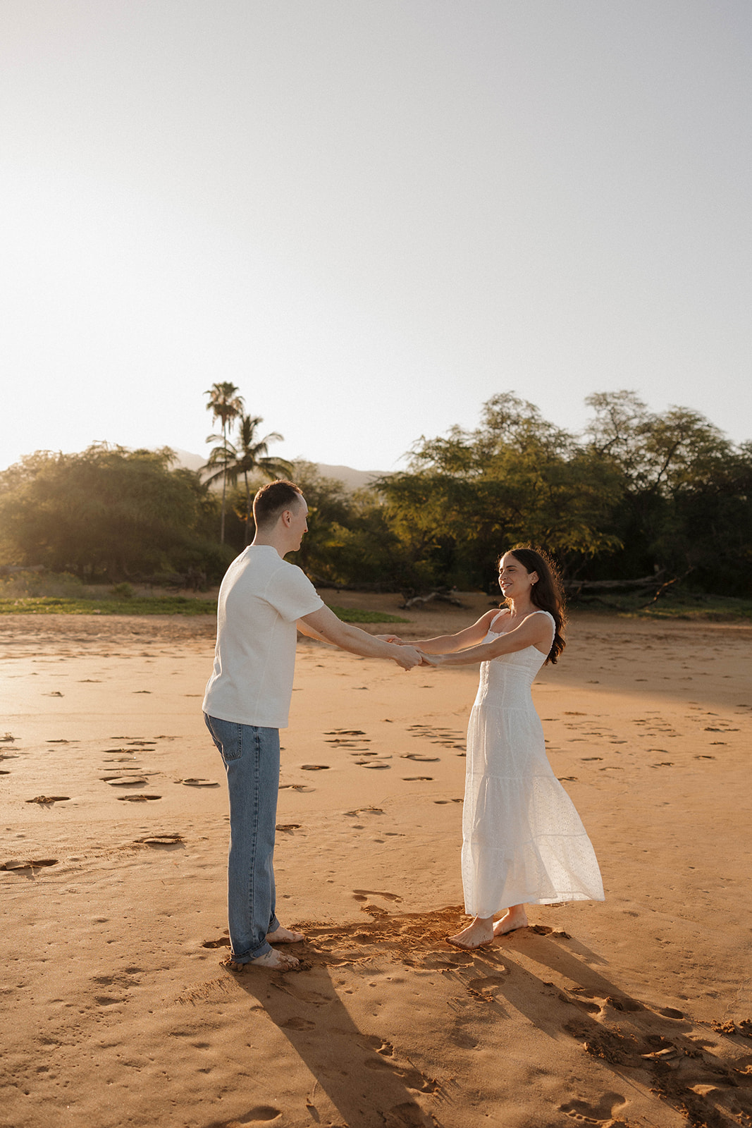 a couple showcasing the perfect neutral engagement photo outfits in Hawaii 