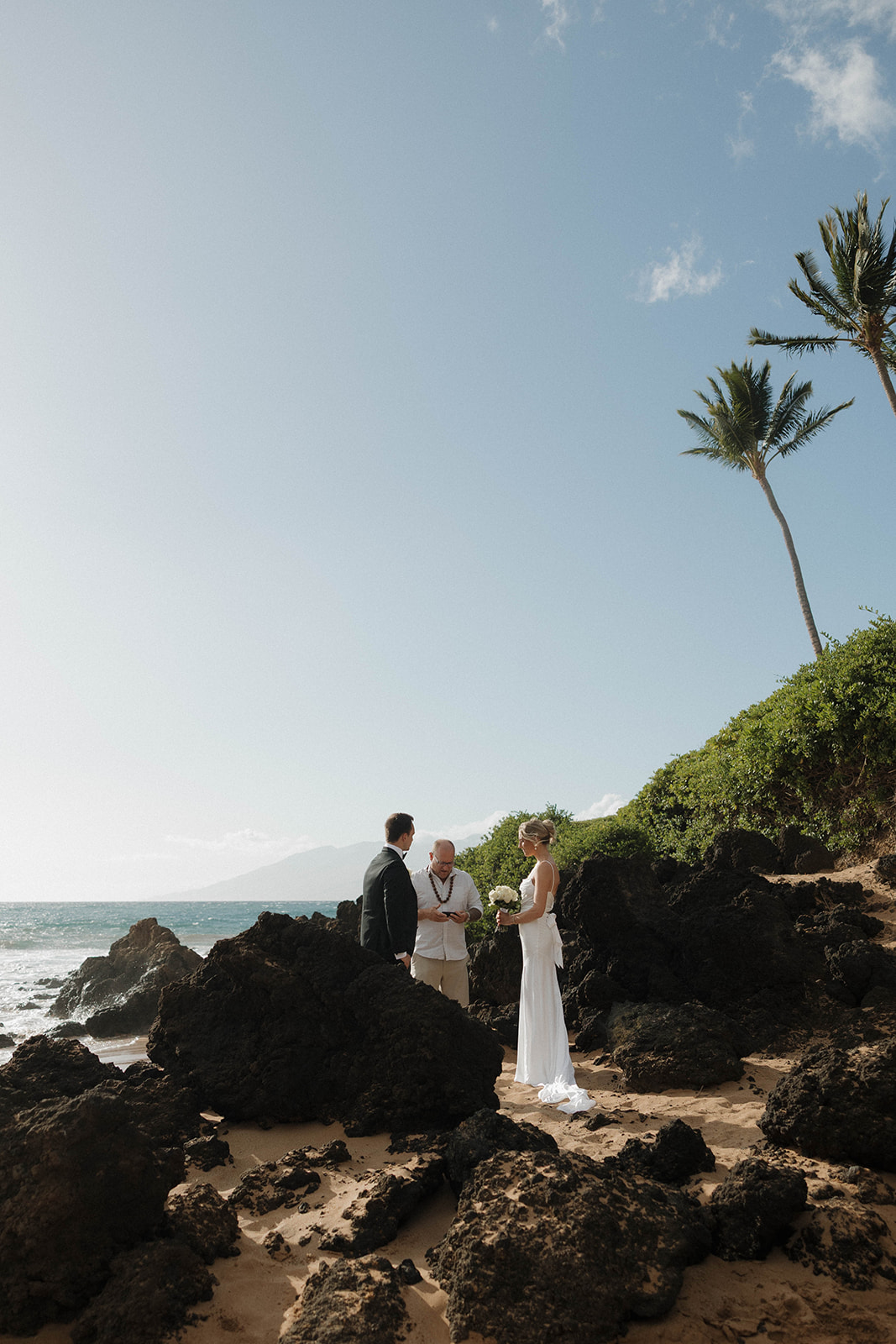 a Maui elopement on the beach with black lava rocks 