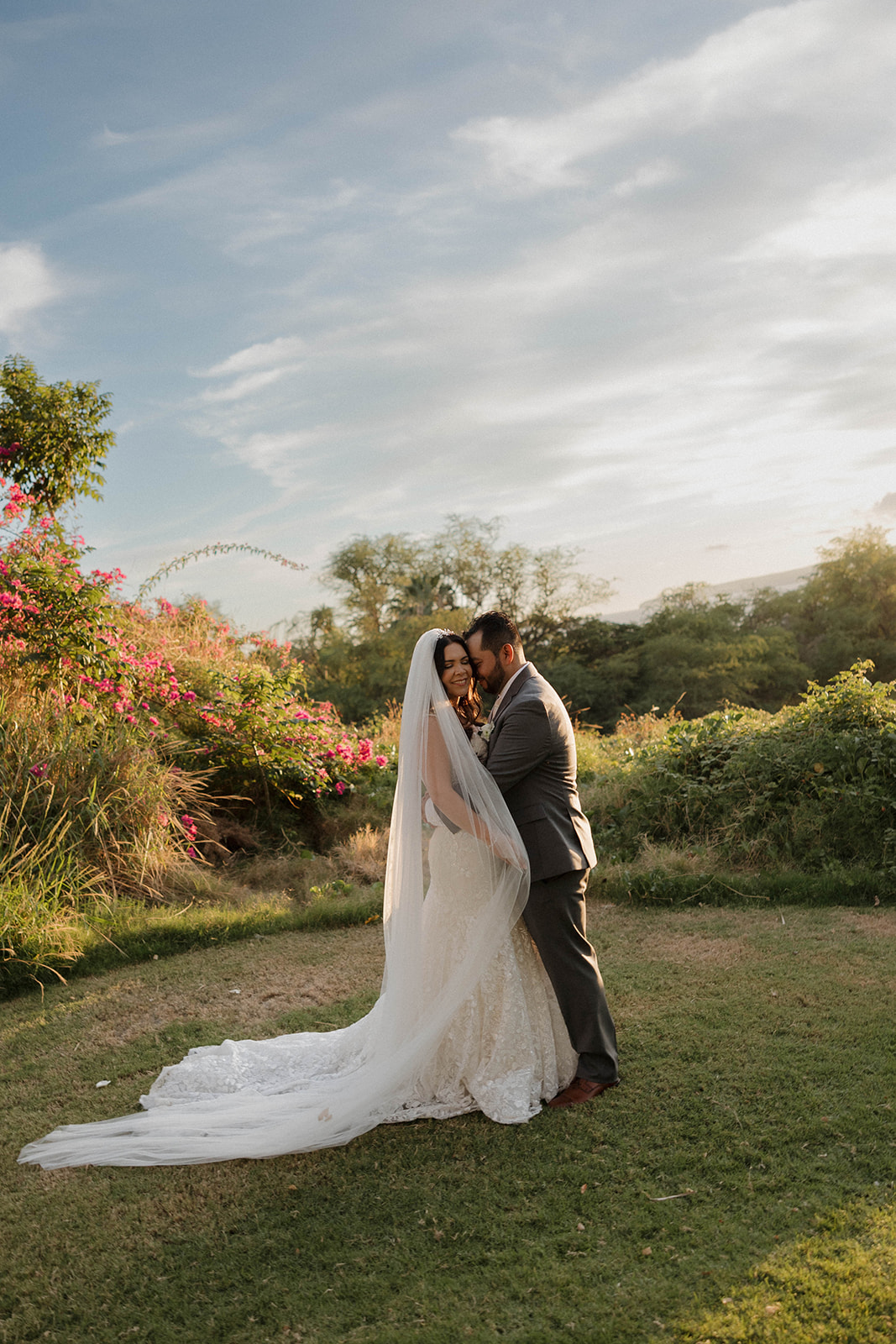 bride and groom portraits in Maui with lots of greenery behind them 