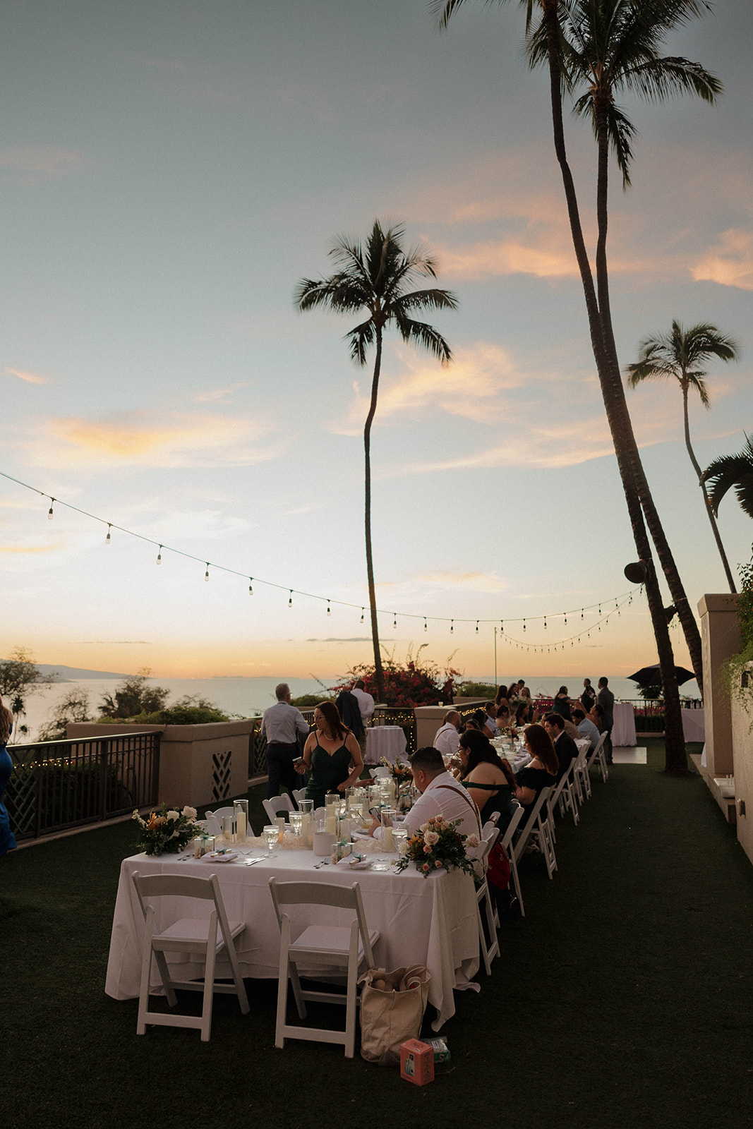beautiful reception tables with palm trees for a Maui wedding
