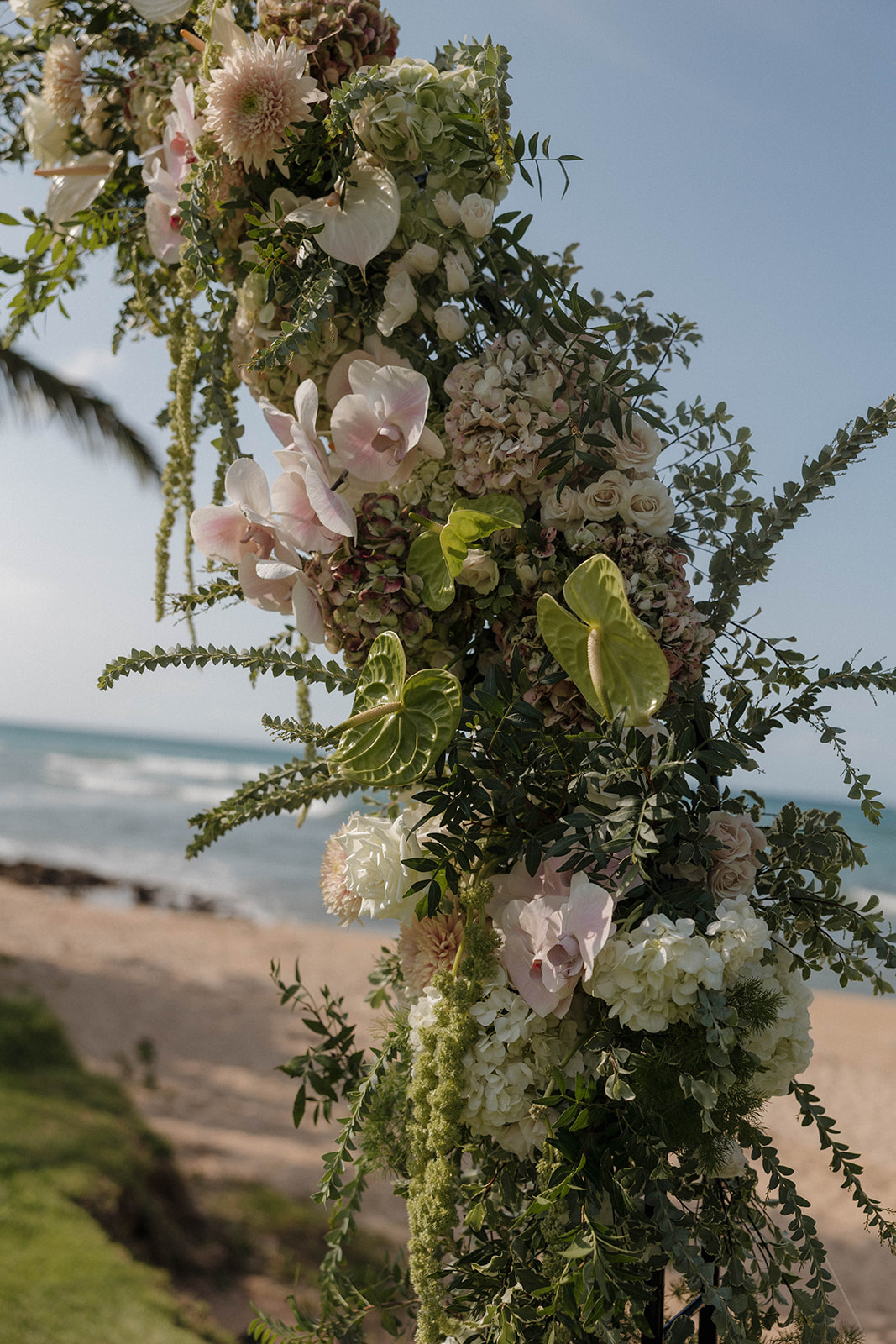 gorgeous tropical wedding florals on an arch for a Maui wedding