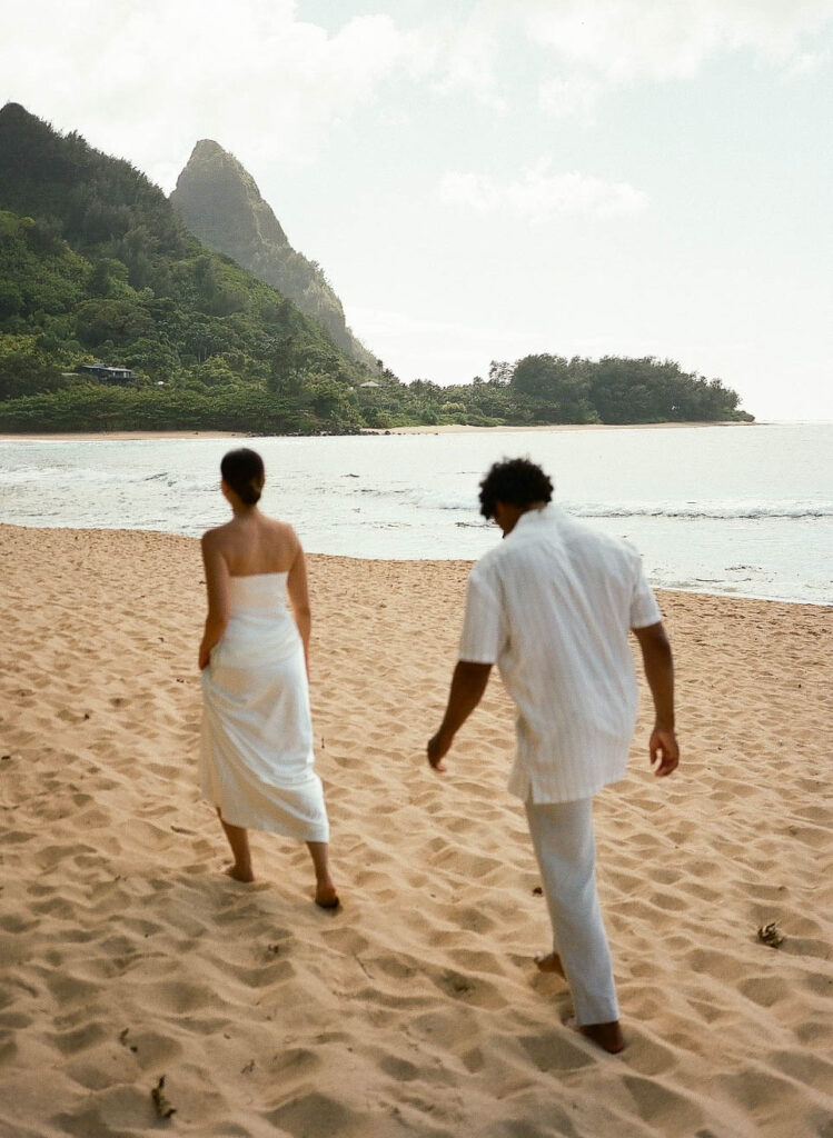 Couple walking together on the beach in Maui during their bride and groom portraits.
