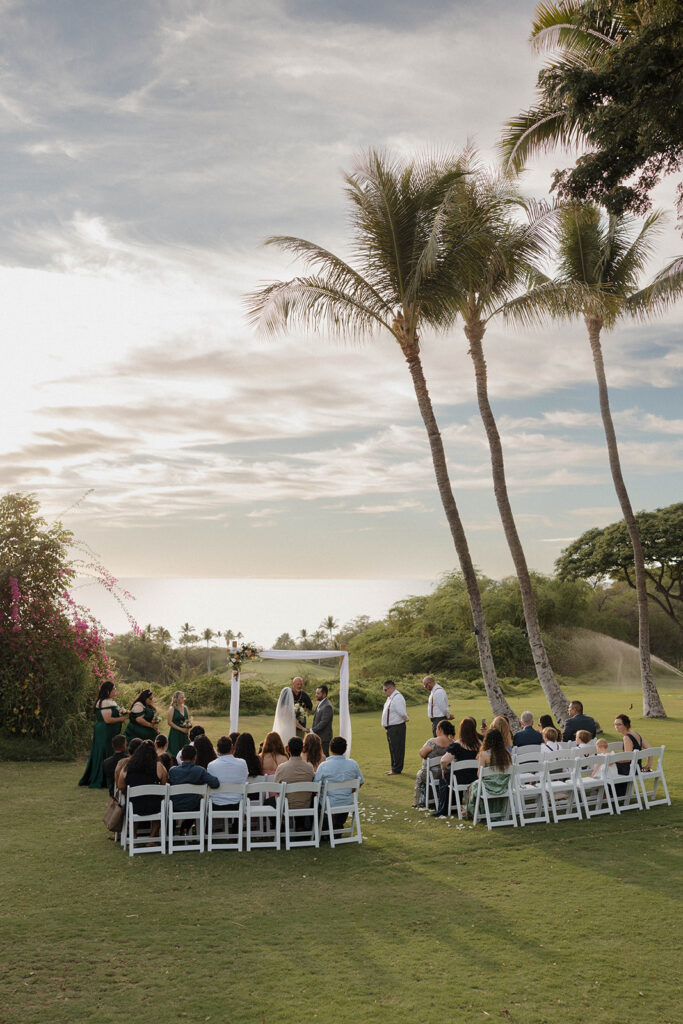A stunning wide shot of a Maui wedding ceremony at sunset.