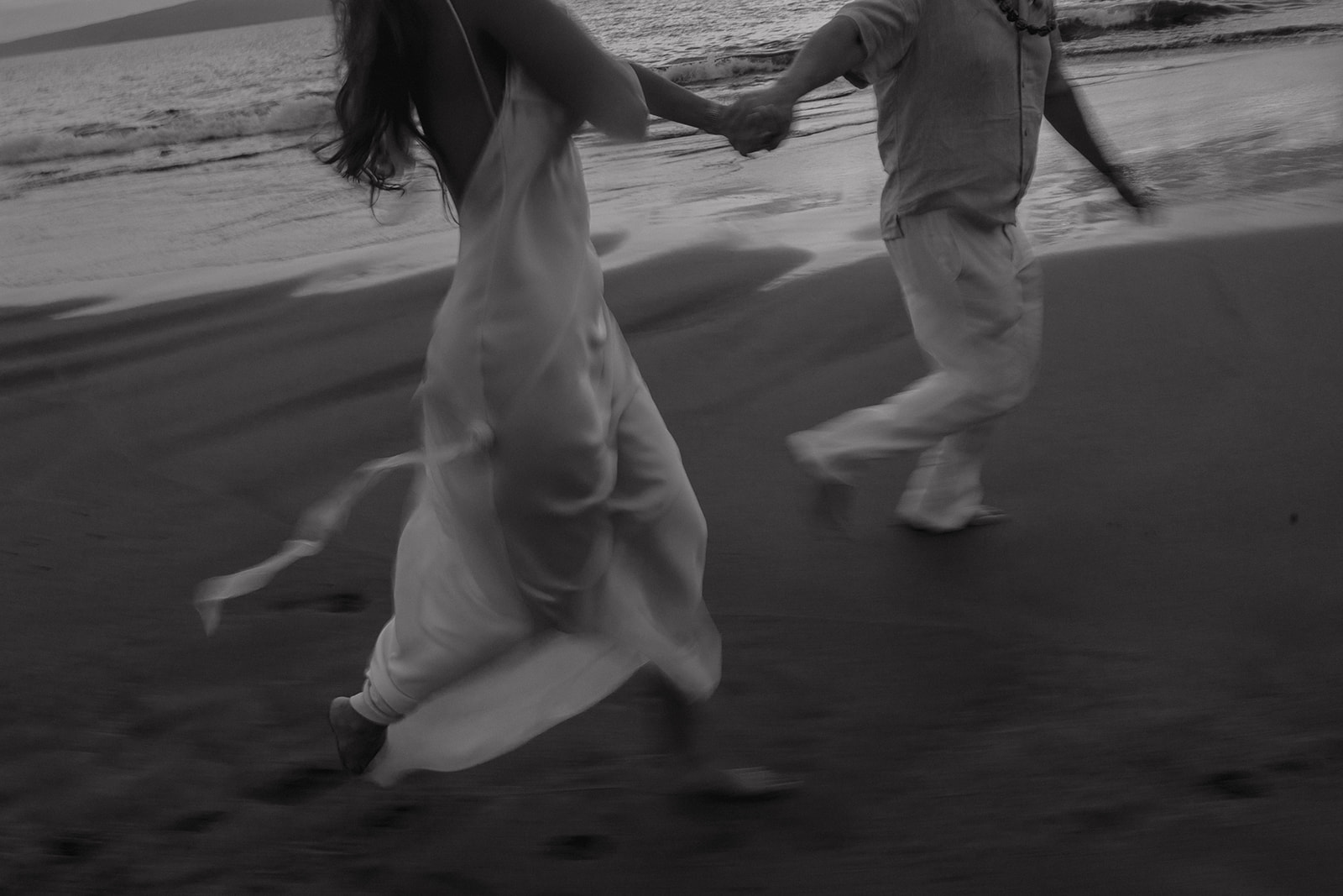 documentary style wedding photos couple running on the beach blurry running pics