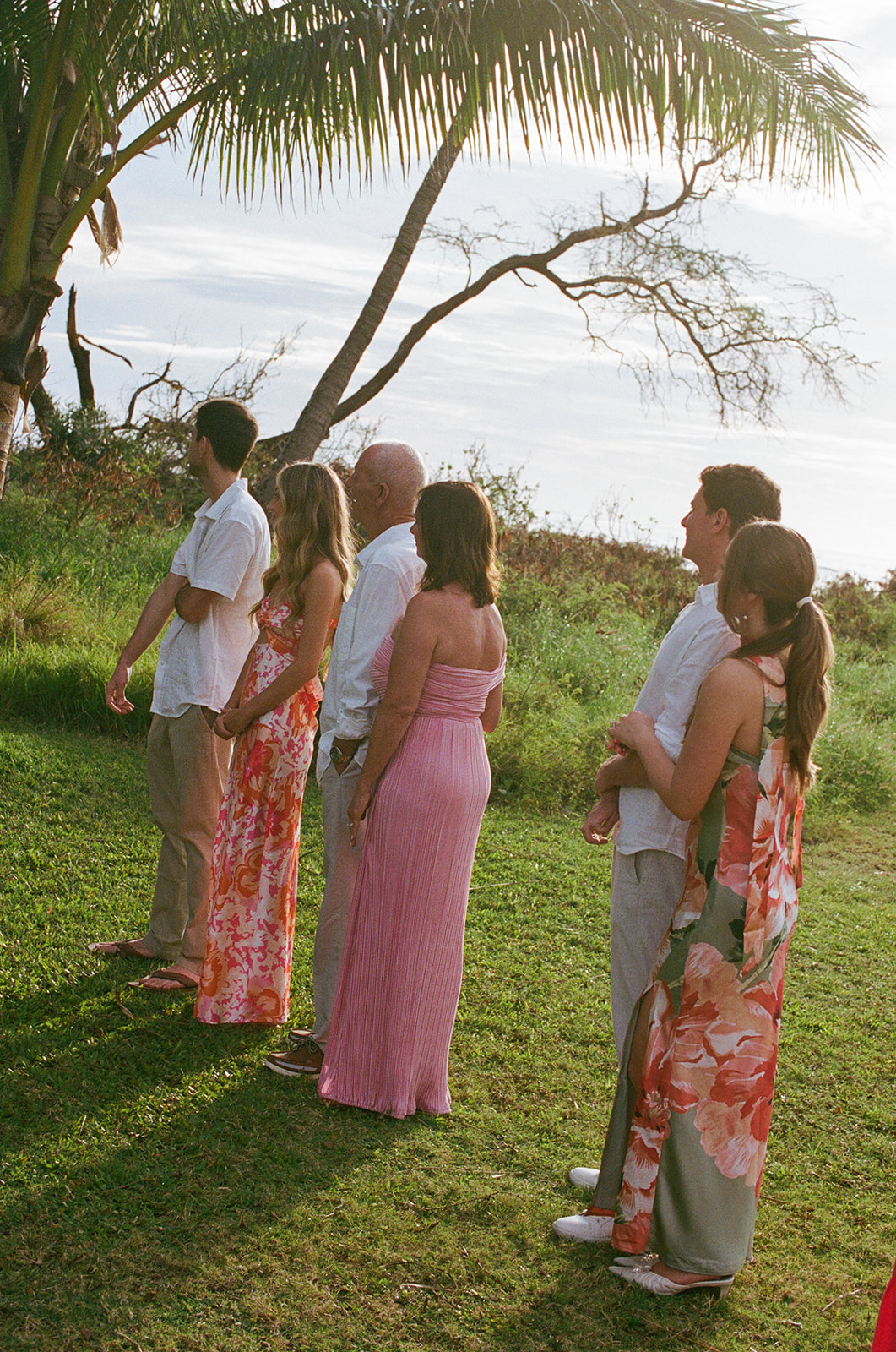 Wedding guests watching the ceremony outdoors in Hawaii
