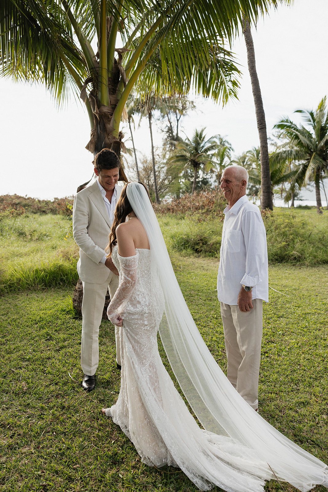 Groom smiling as bride approaches during an intimate outdoor Maui elopement ceremony
