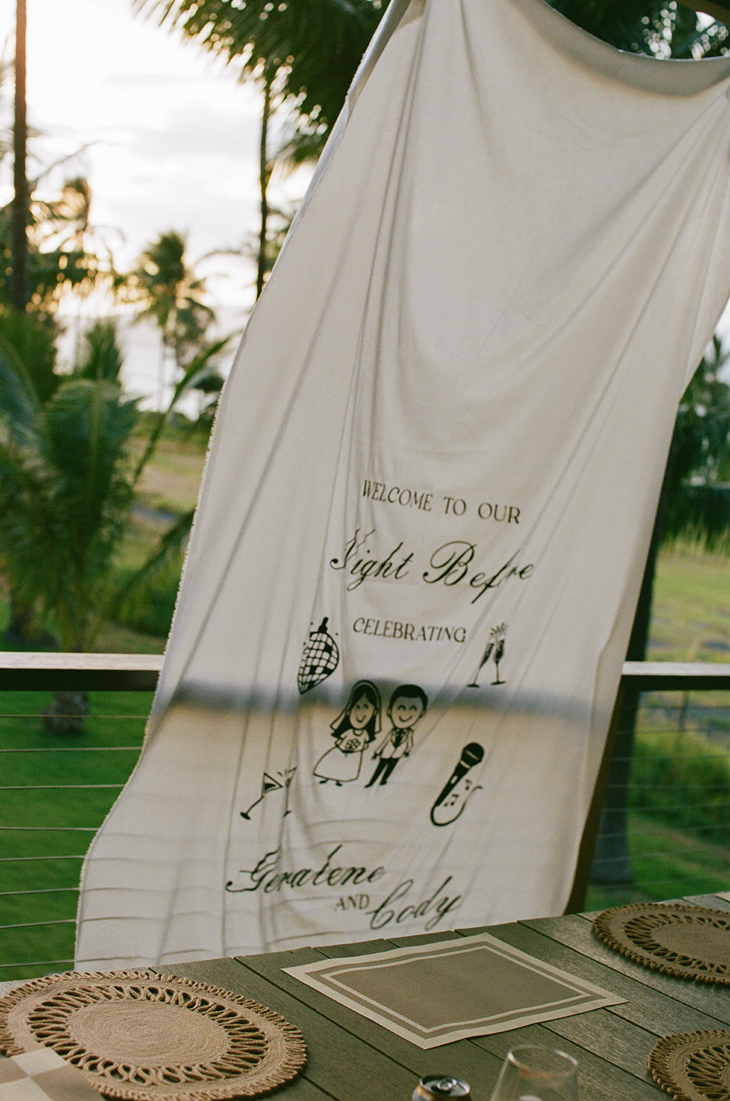 Wedding film photography of a welcome banner reading "Welcome to our Night Before" hung for the rehearsal dinner
