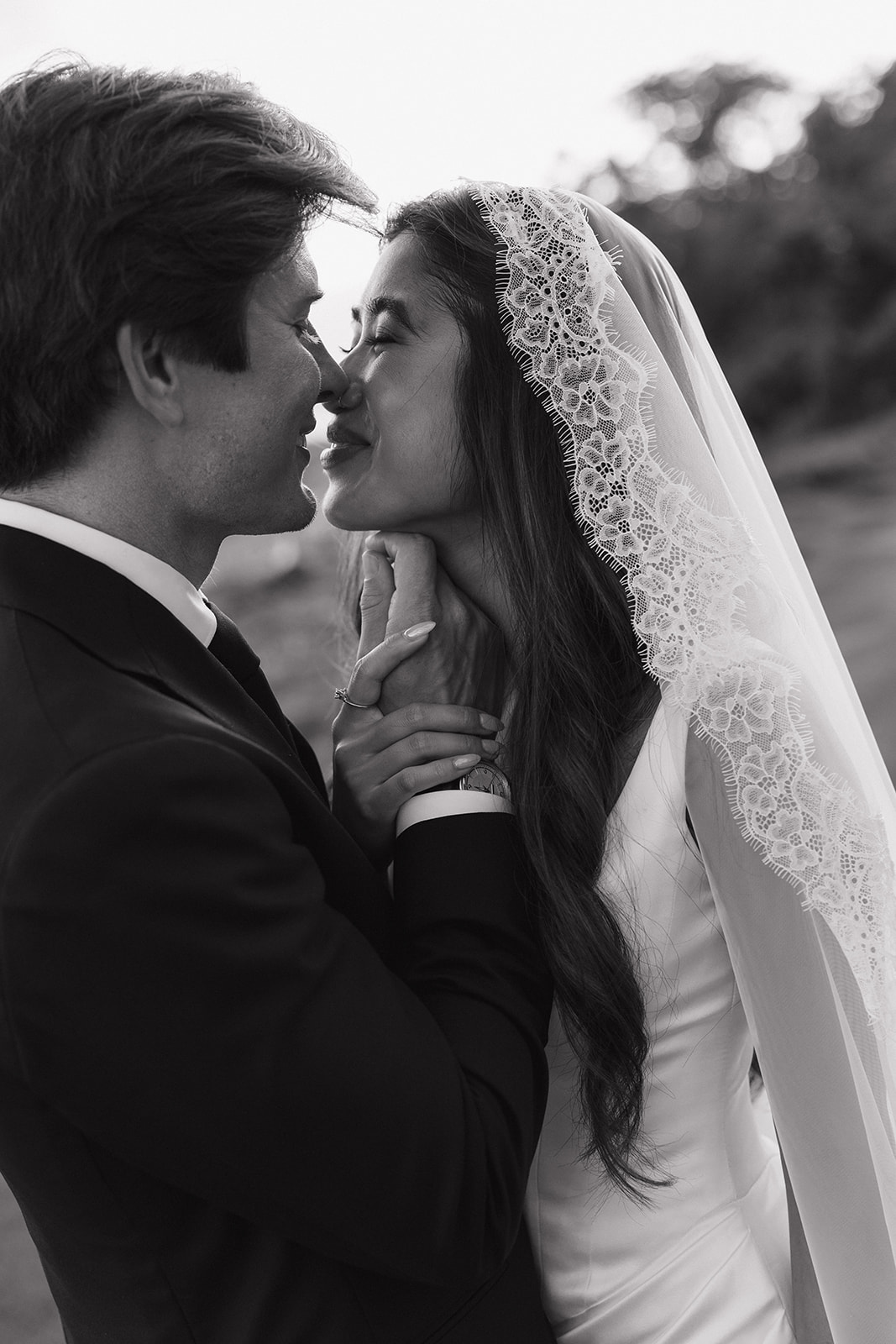 Wedding film photography black and white close-up of the bride and groom about to kiss

