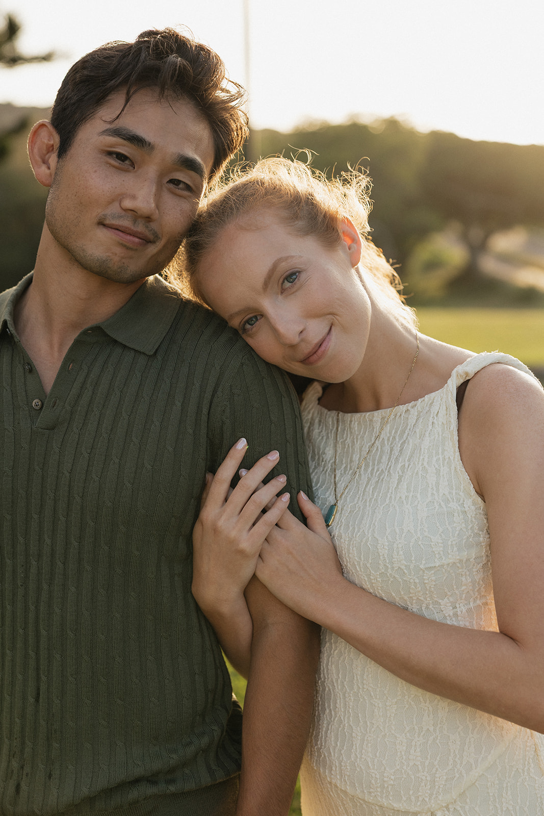 Golden hour couple portrait with her head resting on his shoulder during a sunset session at the Maui Pineapple Chapel.